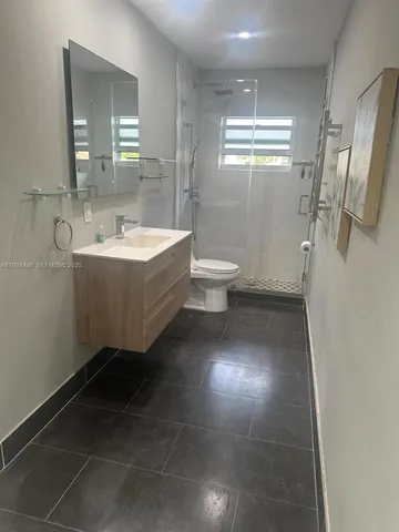 a spacious bathroom with a bathtub sink and toilet