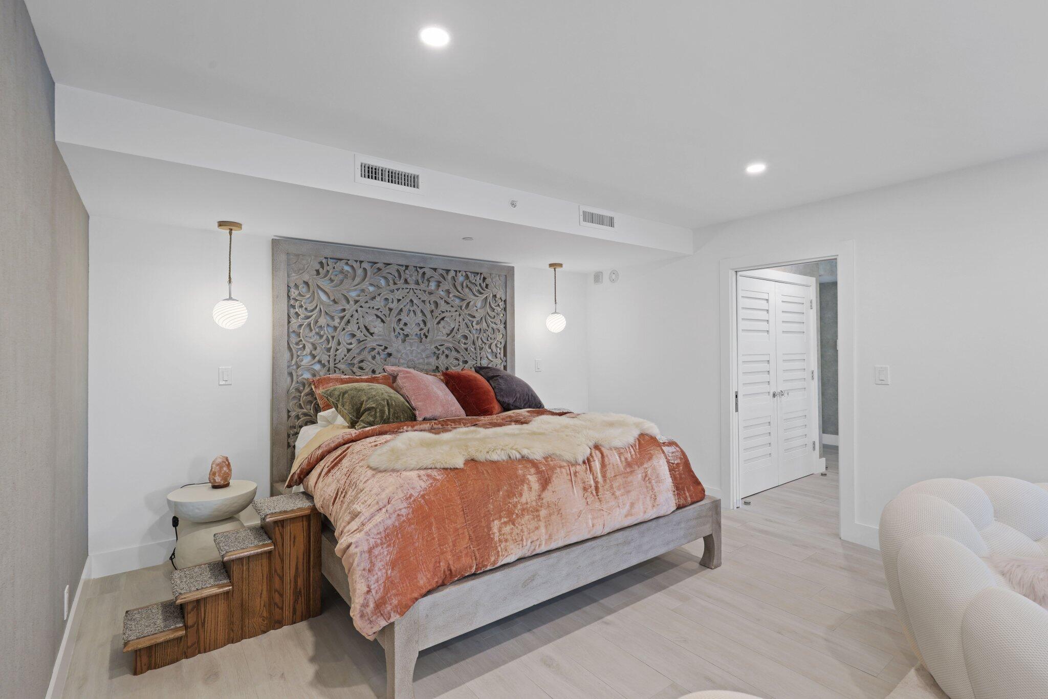 100 Southeast 5th Avenue, Unit 106 Boca Raton, FL 33432 - Photo 24 of 81 a bedroom with a bed and a couch