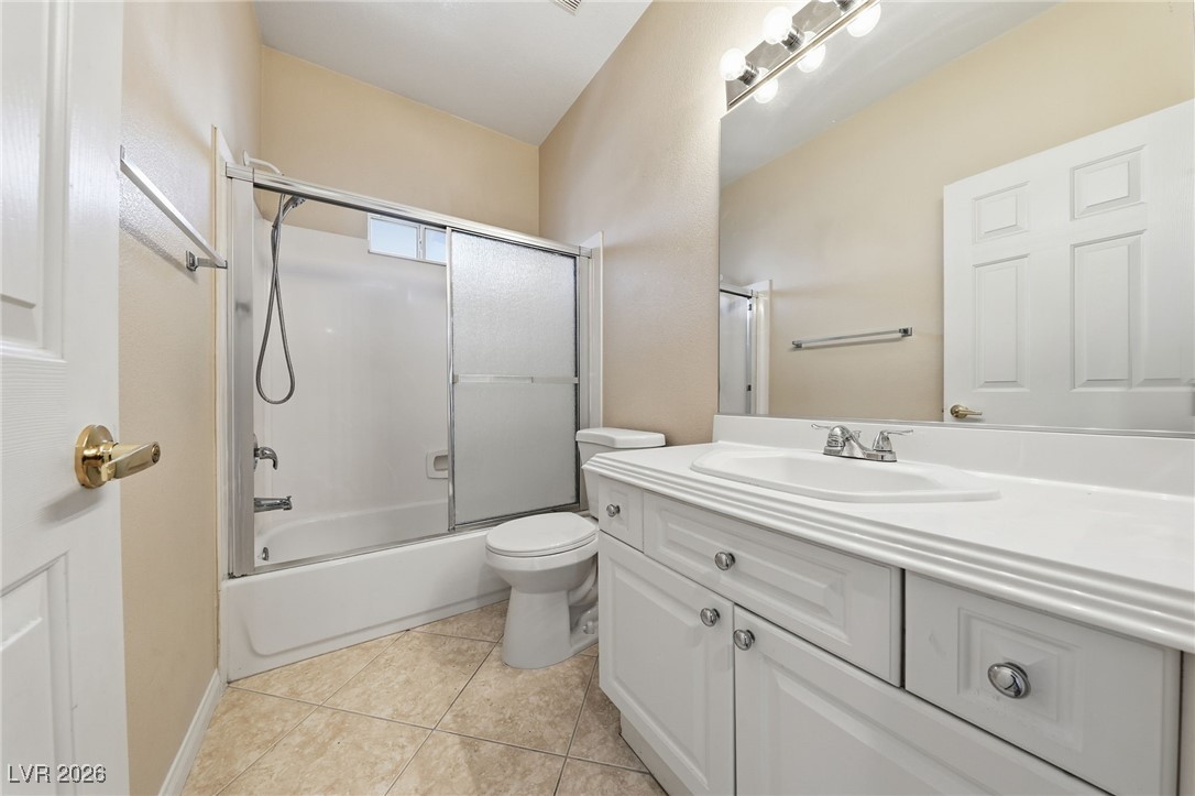 3766 Port Ritchey Street Las Vegas, NV 89147 - Photo 24 of 50 Bathroom with enclosed tub / shower combo, vanity, and light tile patterned floors