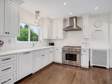 a kitchen with stainless steel appliances a stove sink and cabinets