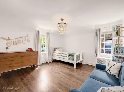 a living room with furniture and two windows