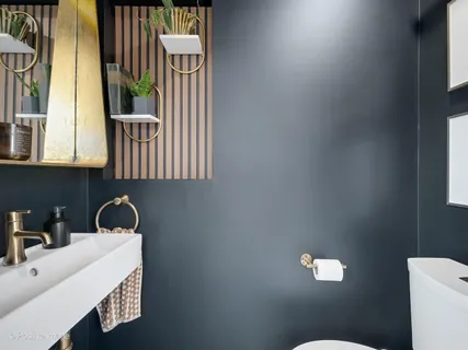 a bathroom with a sink a toilet and a window