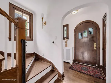 a view of an entryway with wooden floor