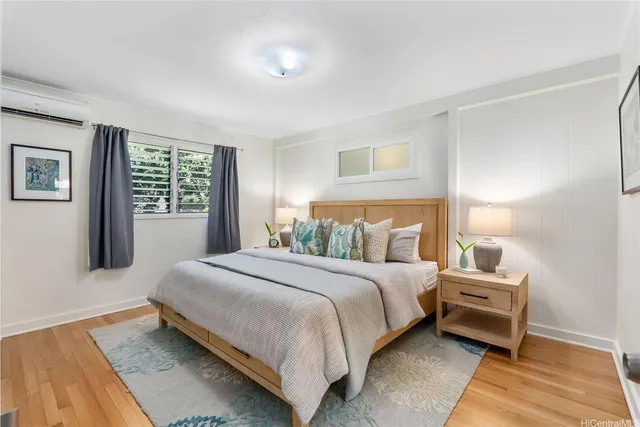 a spacious bedroom with a bed a couch and a window