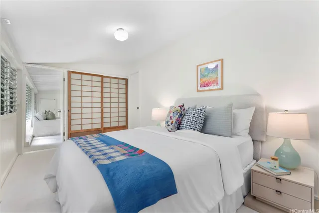 a bed sitting in a bedroom next to a window