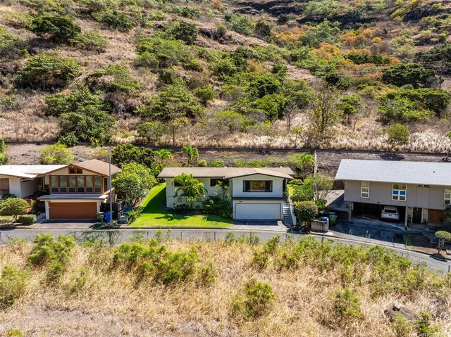 a view of a house with pool plants and a yard