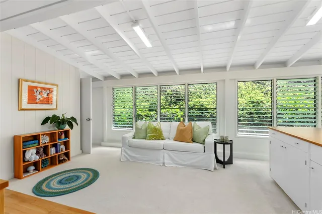 a living room with furniture and wooden floors