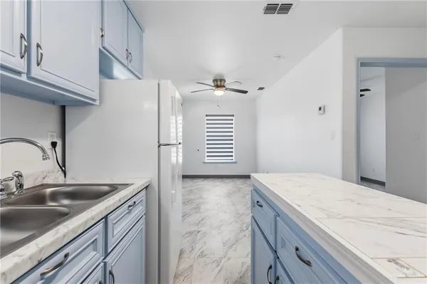 a kitchen with a sink cabinets and appliances