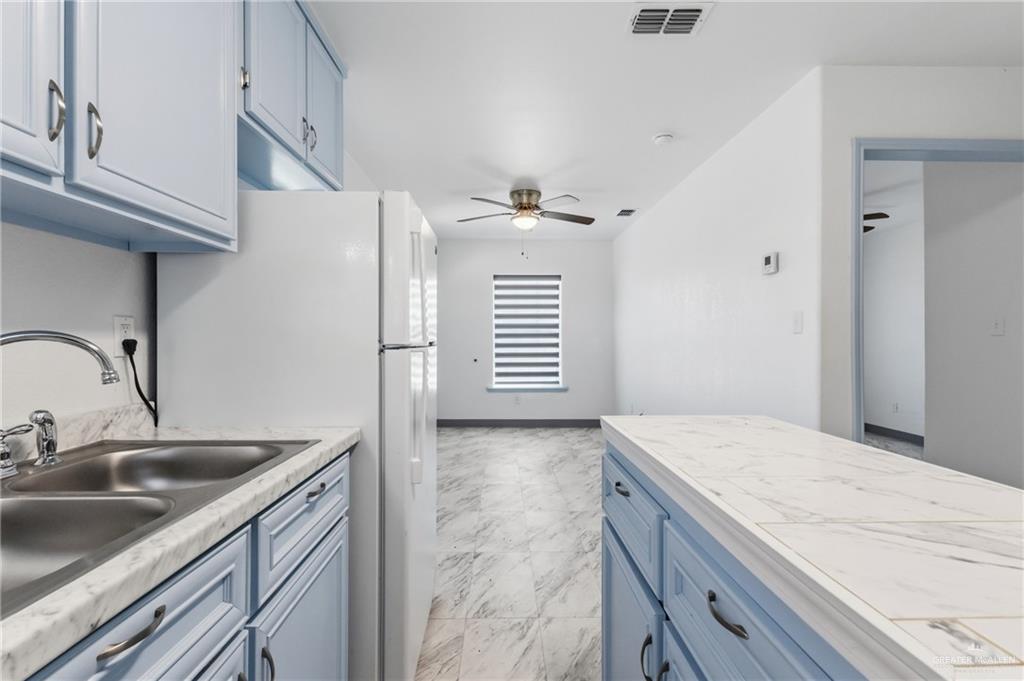 109 Ash Street, Unit B Donna, TX 78537 - Photo 5 of 14 a kitchen with a sink cabinets and appliances