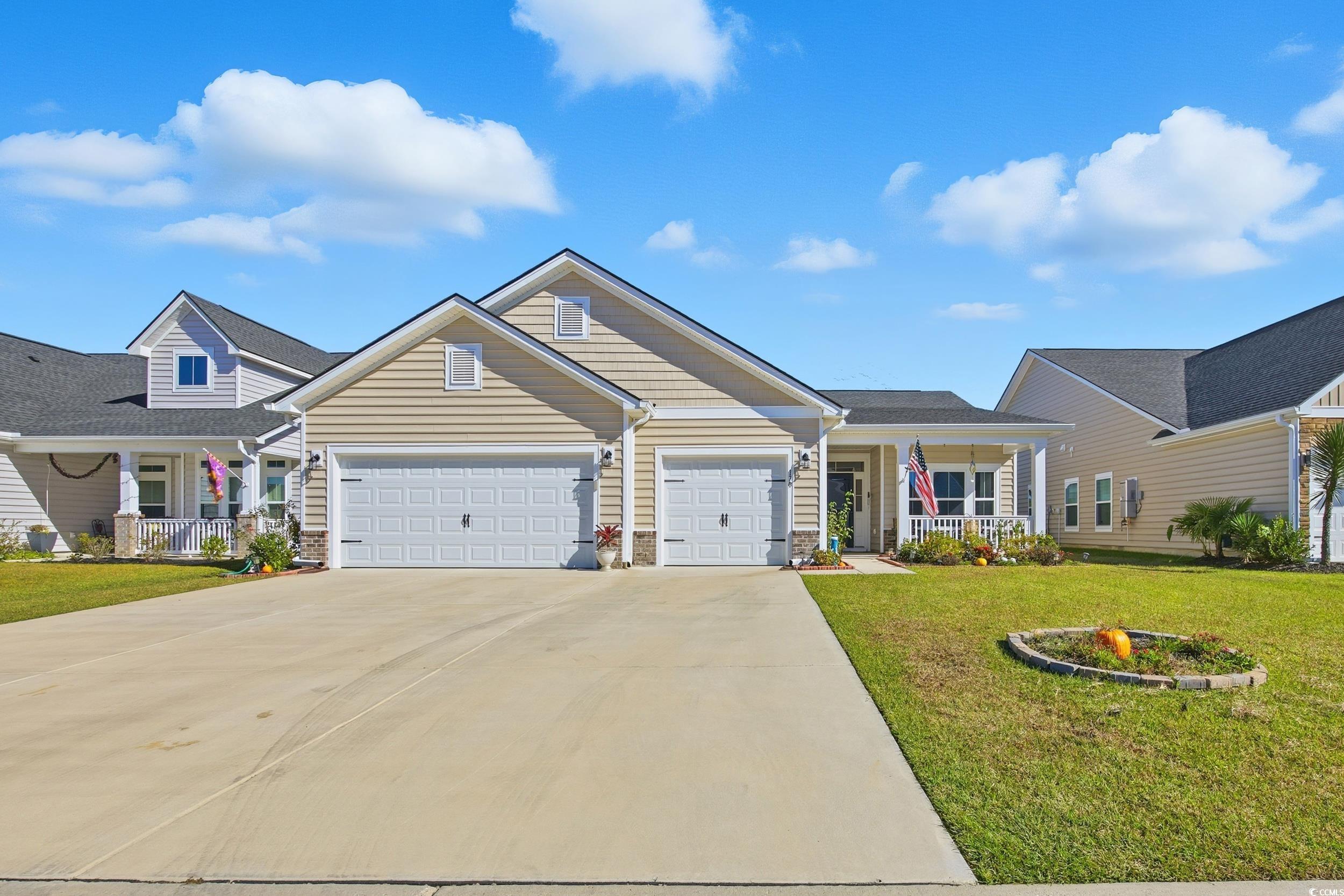 170 New Paradise Way Myrtle Beach, SC 29588 - Photo 1 of 30 View of front of house with a porch, concrete driveway, a front yard, and an attached garage