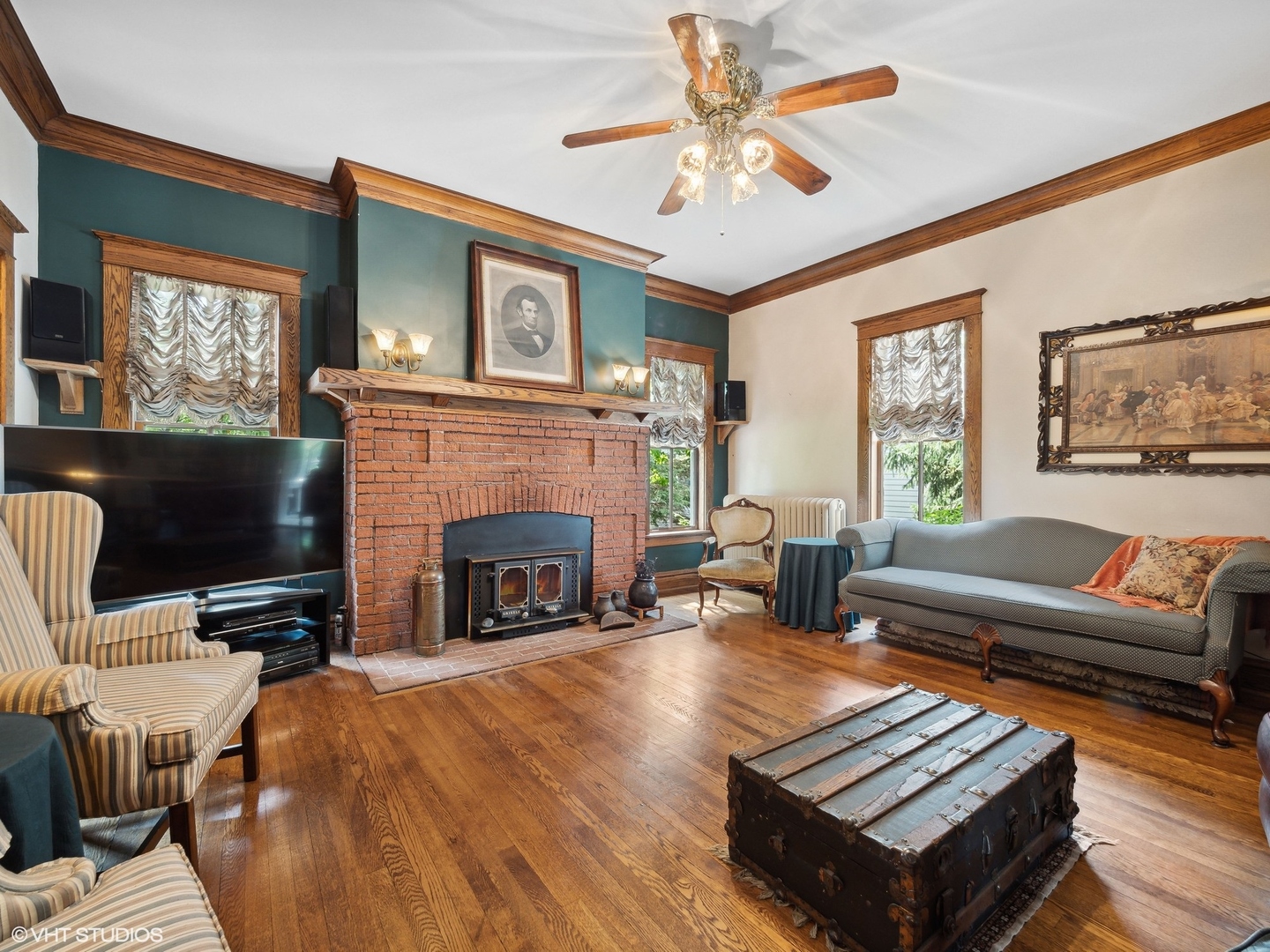 353 South Quentin Road Palatine, IL 60067 - Photo 8 of 34 a living room with furniture a fireplace and a flat screen tv