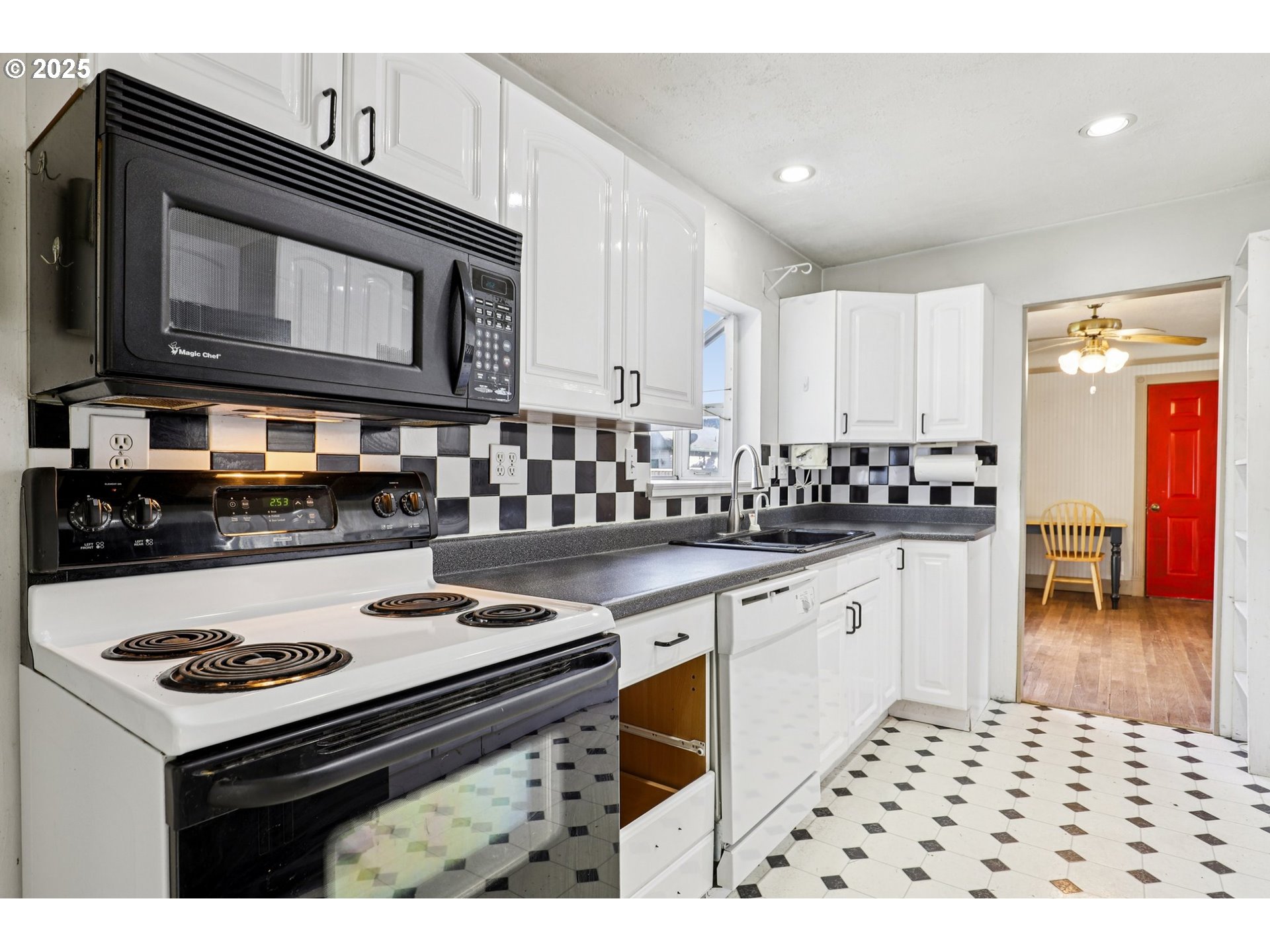 224 Northeast 92nd Place Portland, OR 97220 - Photo 17 of 43 a kitchen with stainless steel appliances a stove a microwave a sink and cabinets