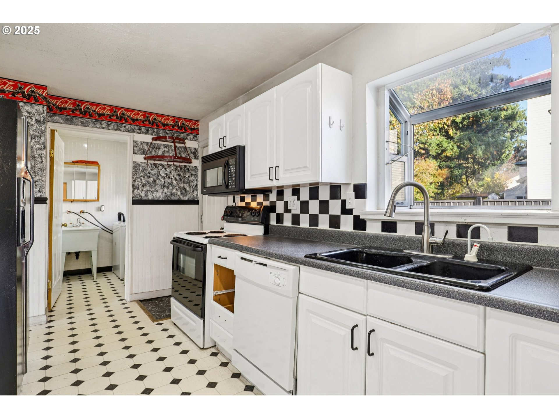 224 Northeast 92nd Place Portland, OR 97220 - Photo 19 of 43 a kitchen with a stove a sink and a refrigerator
