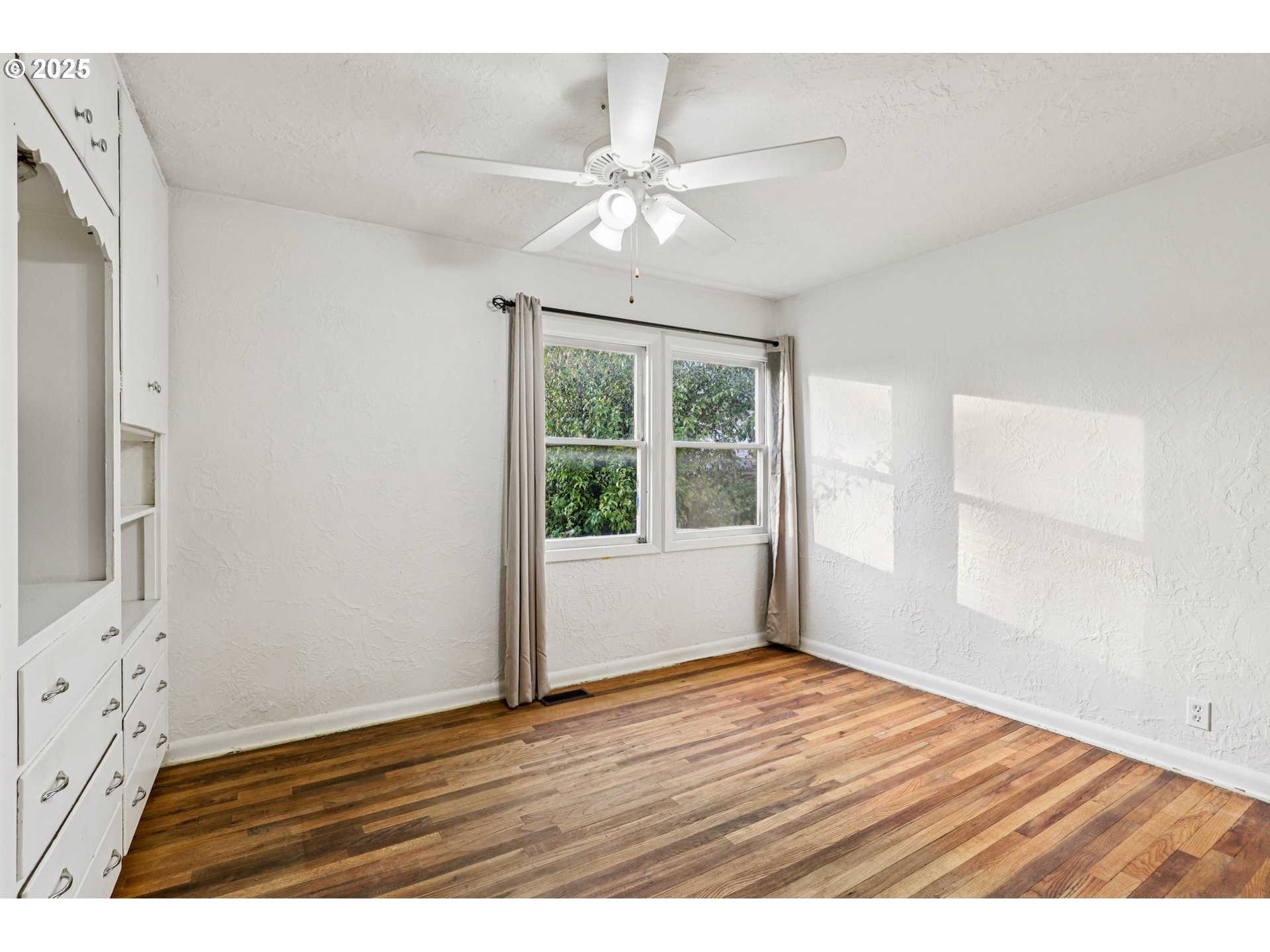 224 Northeast 92nd Place Portland, OR 97220 - Photo 23 of 43 an empty room with wooden floor fan and windows