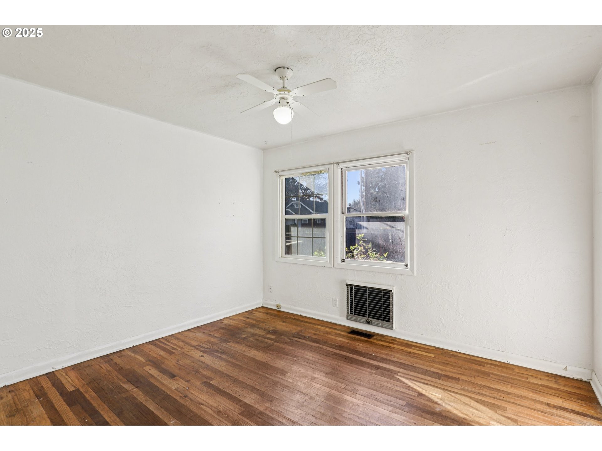 224 Northeast 92nd Place Portland, OR 97220 - Photo 27 of 43 a view of empty room with wooden floor and fan