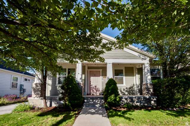Craftsman-style exterior with light green siding and white trim