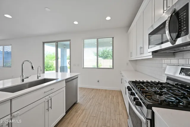 a kitchen with granite countertop a stove and a sink
