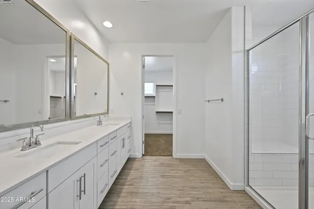 a spacious bathroom with a double vanity sink and a mirror
