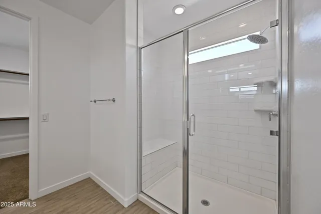 a bathroom with a glass shower door