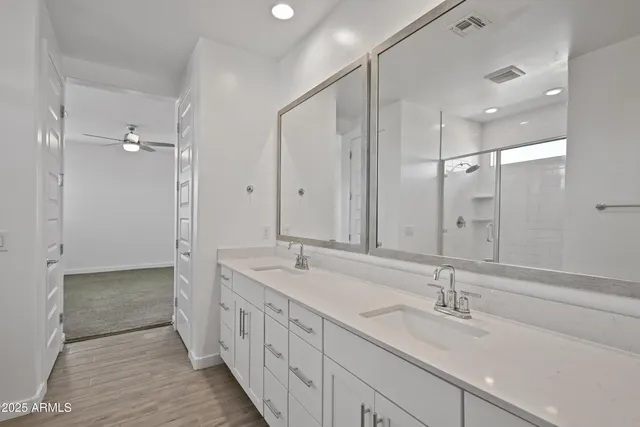a bathroom with a double vanity sink and mirror