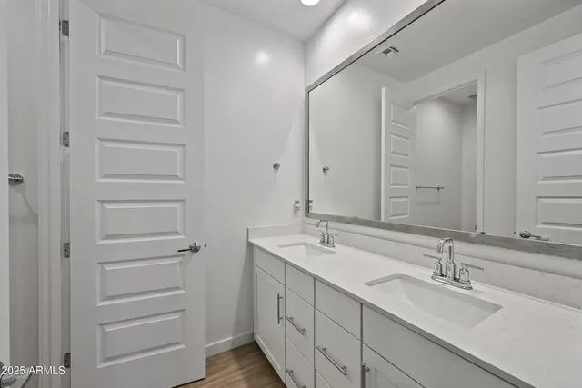 a bathroom with a double vanity sink and mirror