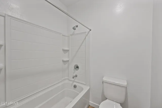 a bathroom with a bathtub and toilet