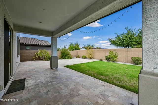 a view of a house with a yard and a garage