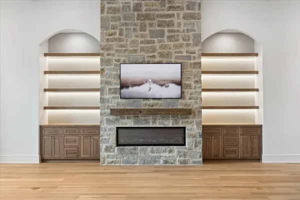 a room with a fireplace and a wooden floor