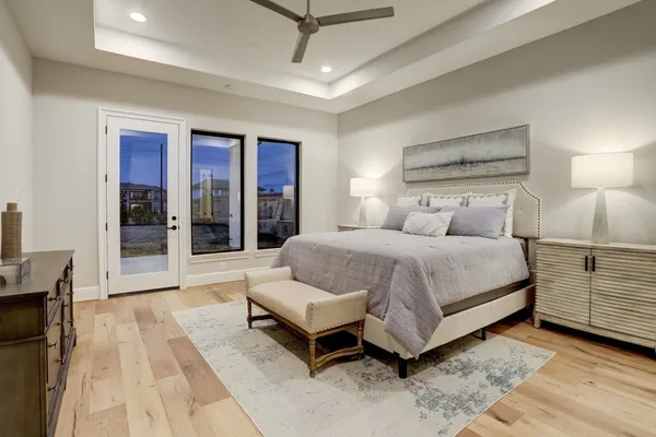 a bedroom with a large bed and a chandelier