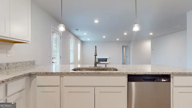 a kitchen with a sink cabinets and window