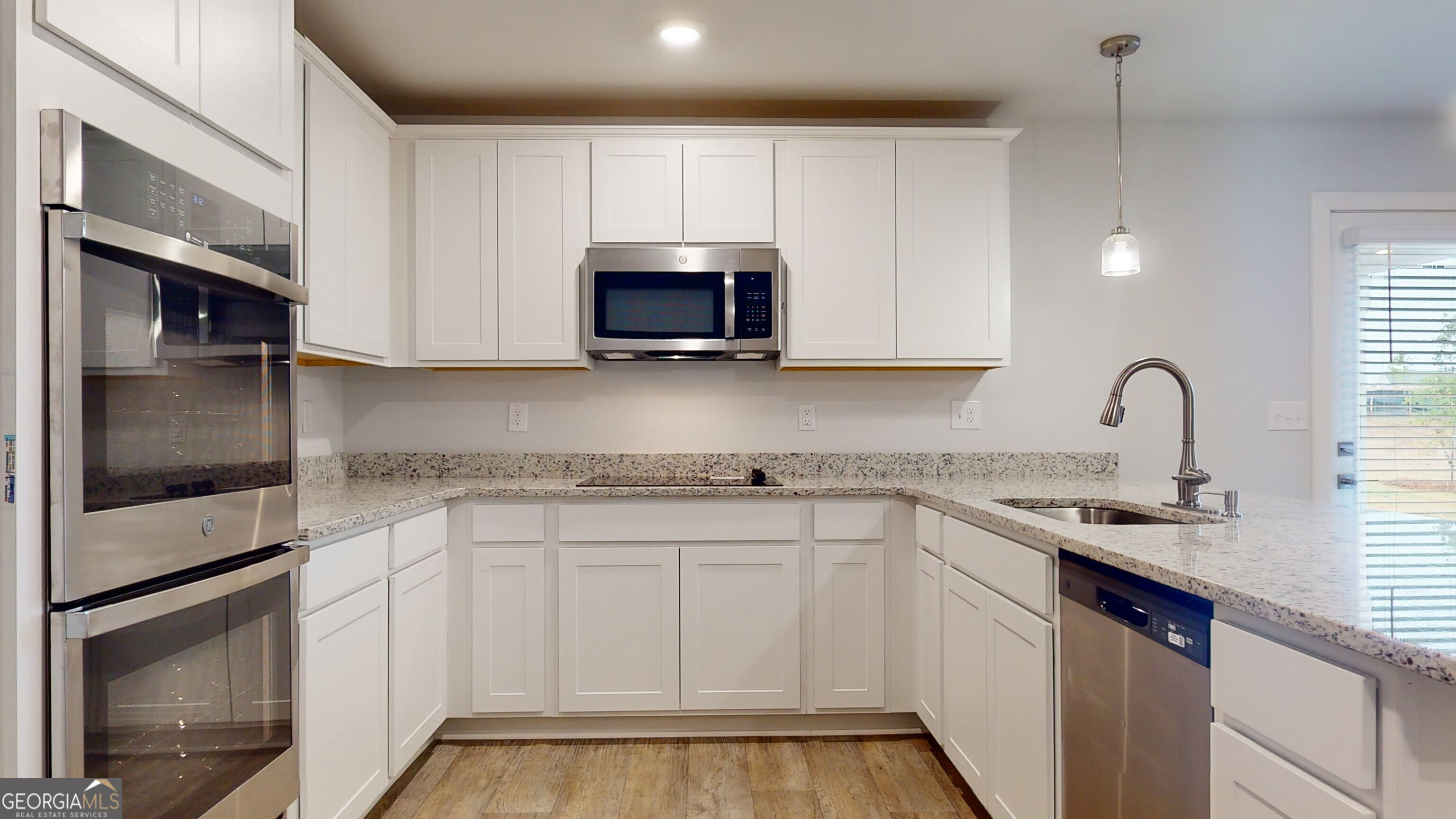 362 Jarrett Street, Unit 48 Fairburn, GA 30213 - Photo 4 of 18 a kitchen with white cabinets sink and stainless steel appliances
