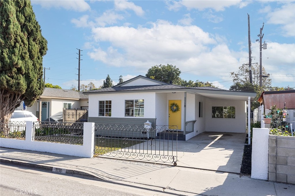 1118 East Joel Street Carson, CA 90745 - Photo 1 of 35 a front view of a house with a garden