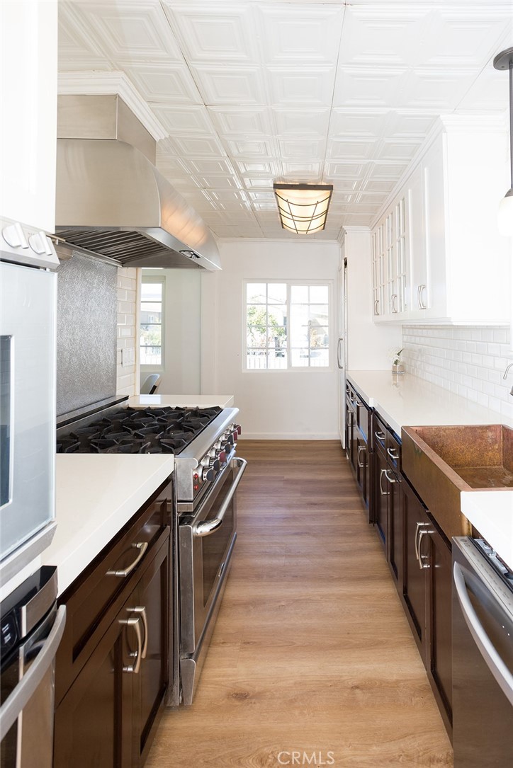 1118 East Joel Street Carson, CA 90745 - Photo 13 of 35 a kitchen with stainless steel appliances granite countertop a stove a sink and a refrigerator
