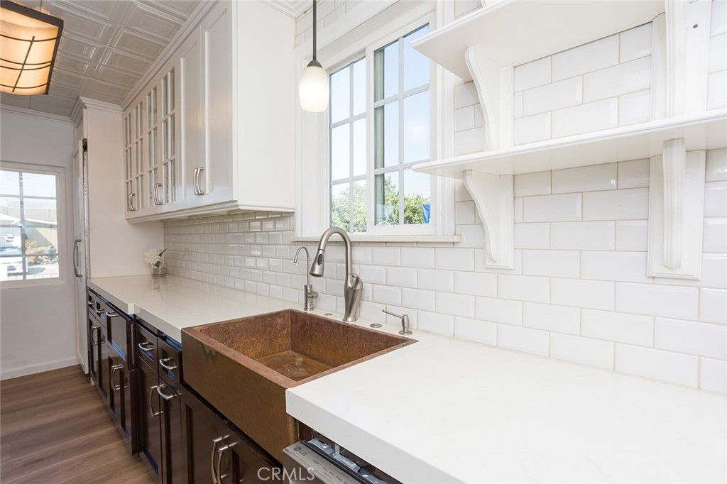 1118 East Joel Street Carson, CA 90745 - Photo 14 of 35 a kitchen with a stove a sink and a window