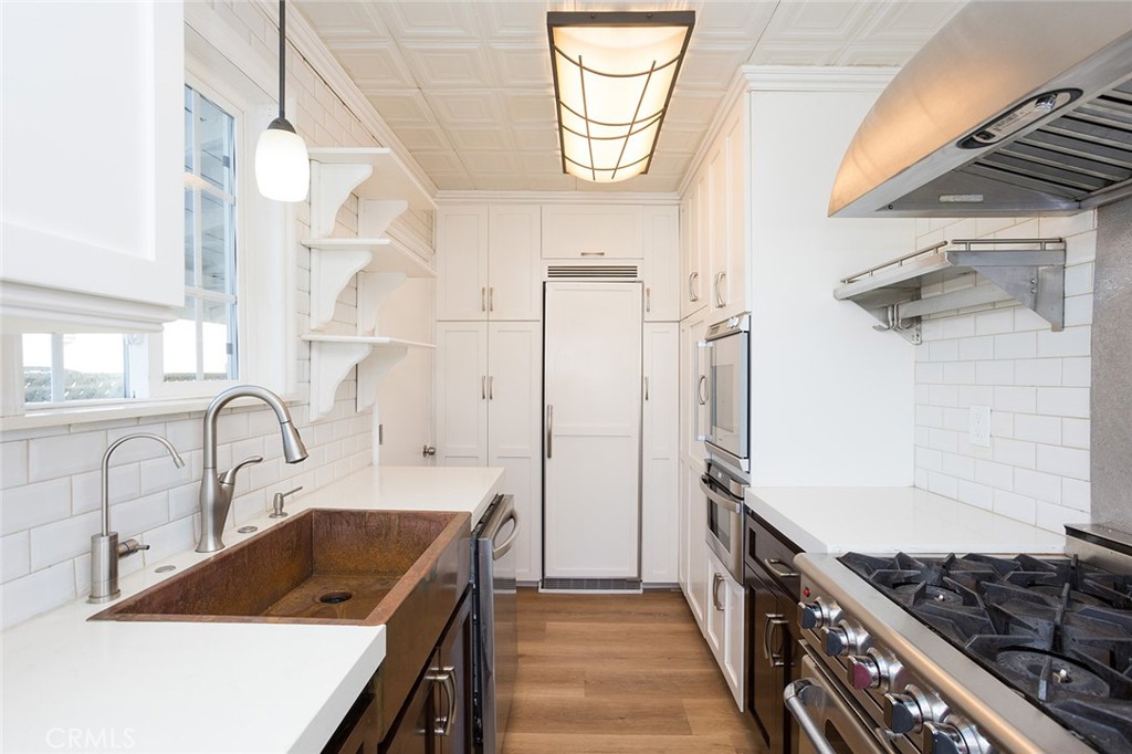 1118 East Joel Street Carson, CA 90745 - Photo 15 of 35 a kitchen with stainless steel appliances a sink stove and refrigerator