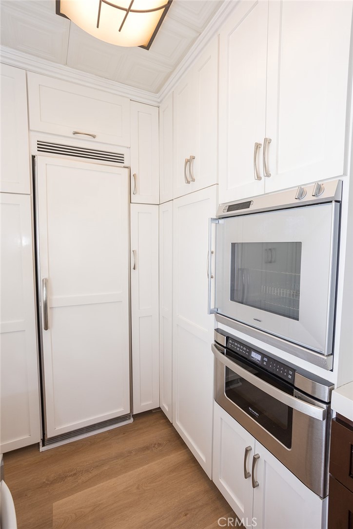 1118 East Joel Street Carson, CA 90745 - Photo 18 of 35 a kitchen with granite countertop cabinets and steel stainless steel appliances