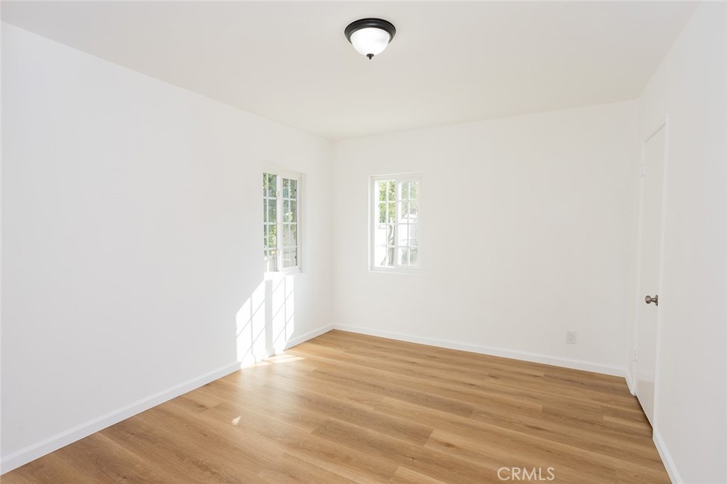 1118 East Joel Street Carson, CA 90745 - Photo 20 of 35 a view of an empty room with wooden floor and a window