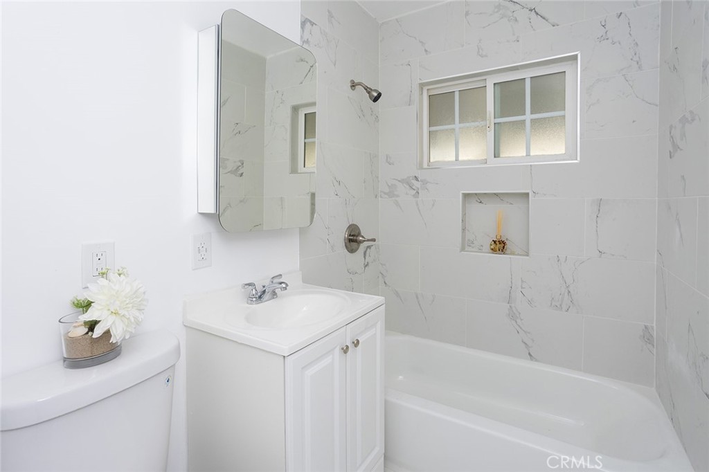1118 East Joel Street Carson, CA 90745 - Photo 25 of 35 a bathroom with a sink a bathtub and a shower