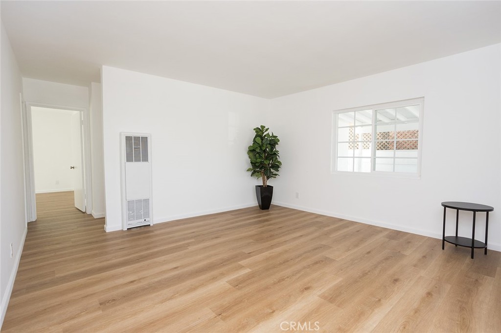 1118 East Joel Street Carson, CA 90745 - Photo 5 of 35 a view of an empty room with wooden floor and a window