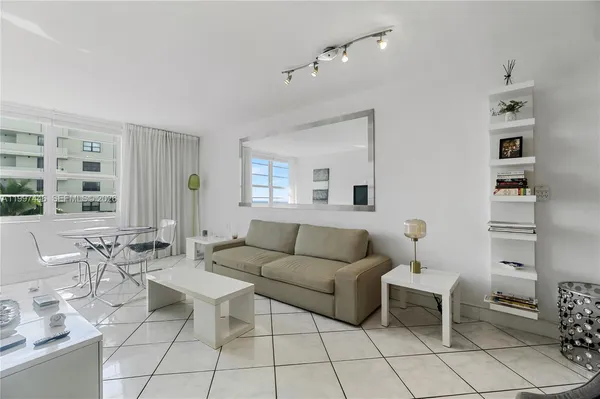 a living room with furniture a rug and a window