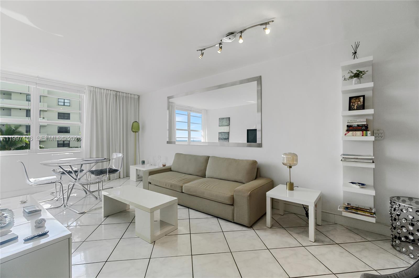 100 Lincoln Road, Unit 638 Miami Beach, FL 33139 - Photo 3 of 19 a living room with furniture a rug and a window