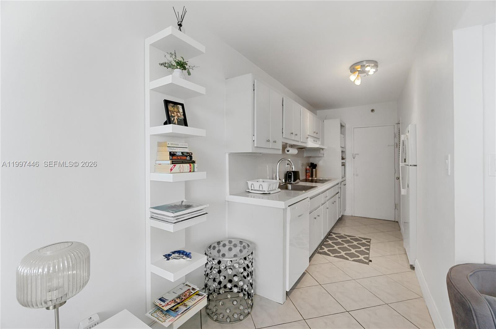 100 Lincoln Road, Unit 638 Miami Beach, FL 33139 - Photo 6 of 19 a kitchen with stainless steel appliances granite countertop a sink a stove a refrigerator and cabinets