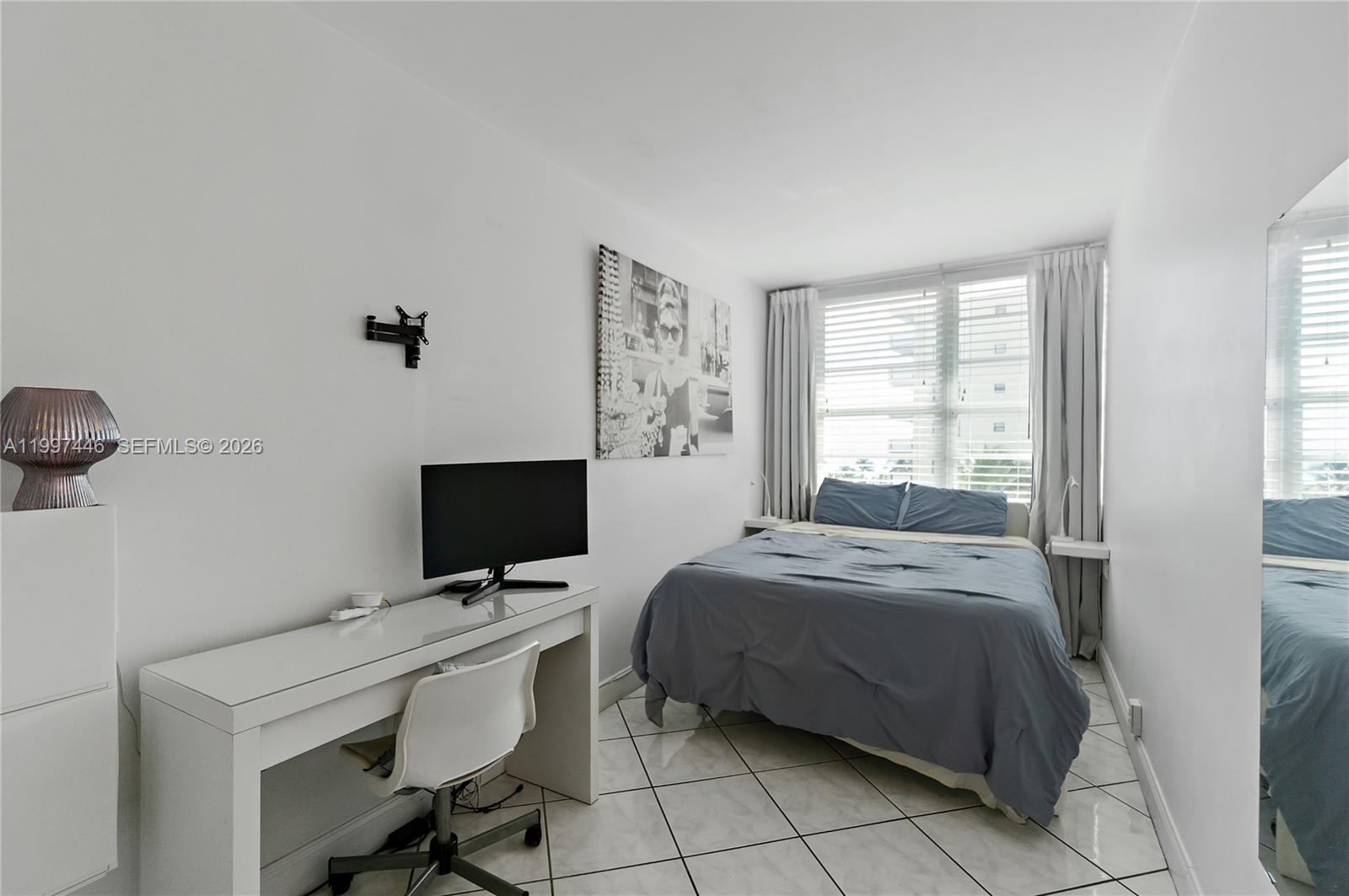 100 Lincoln Road, Unit 638 Miami Beach, FL 33139 - Photo 10 of 19 a bedroom with a bed and a flat screen tv