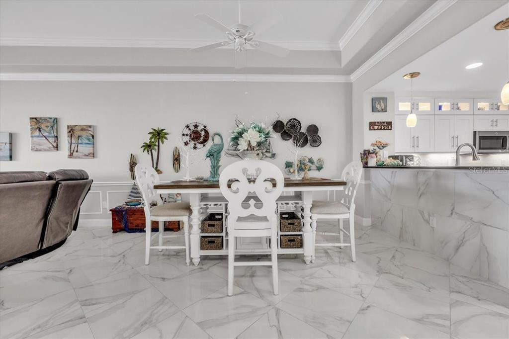 1260 Rio De Janeiro Avenue, Unit 102 Punta Gorda, FL 33983 - Photo 12 of 46 a dining room with furniture and a chandelier