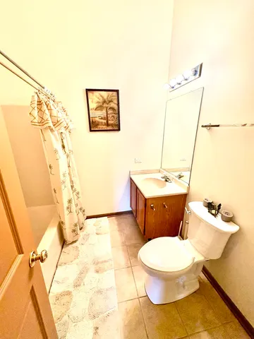 a bathroom with a white toilet and a sink