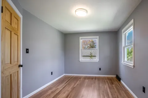 a view of room with window and hardwood floor