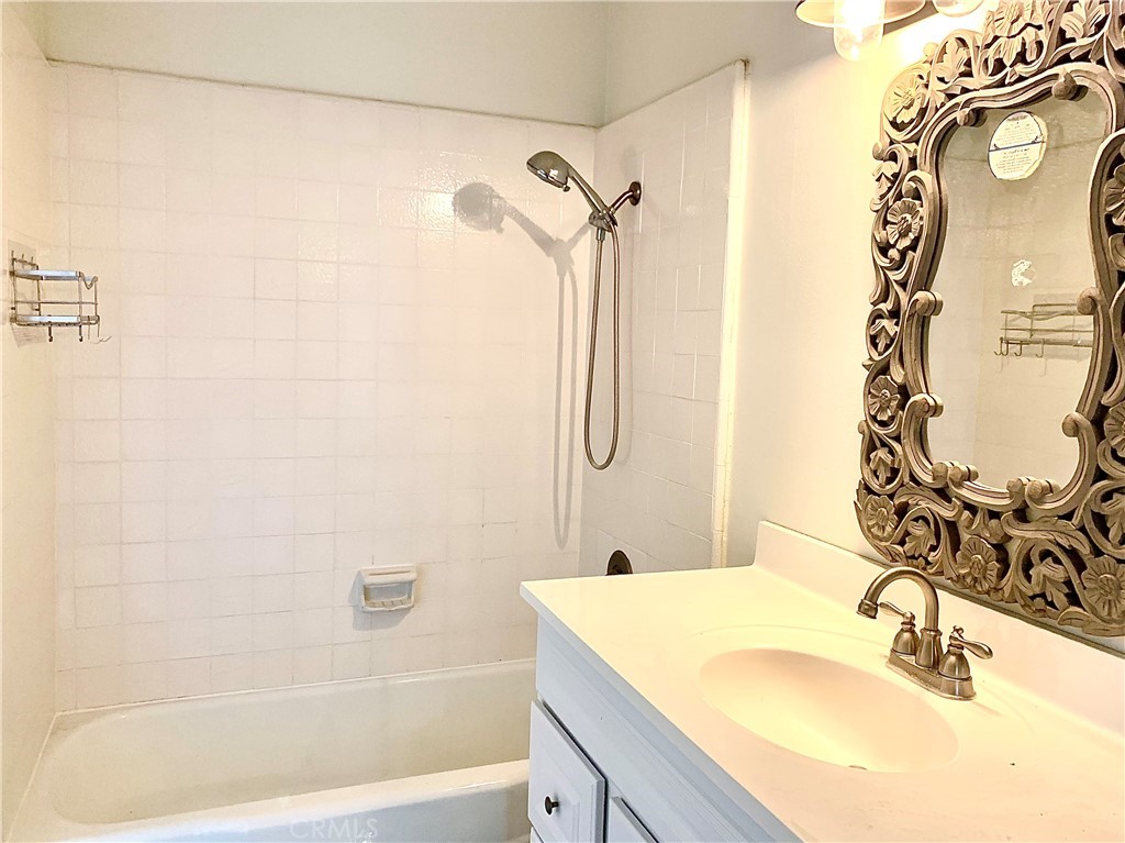 182 Brookline Lane Costa Mesa, CA 92626 - Photo 14 of 21 a bathroom with a granite countertop sink and a mirror