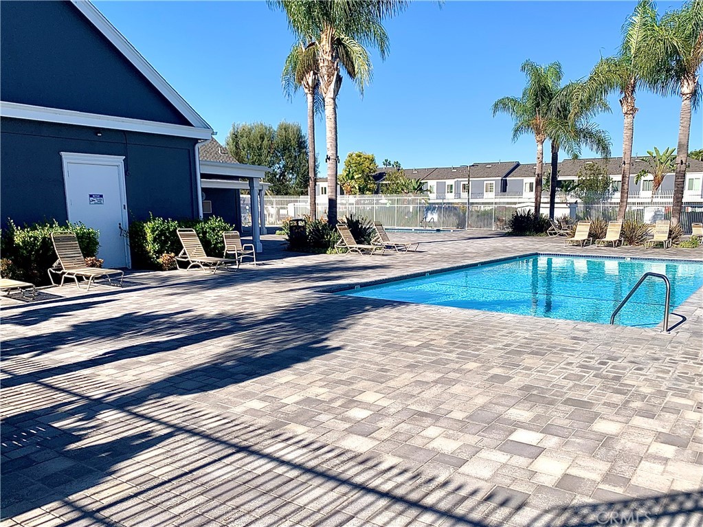 182 Brookline Lane Costa Mesa, CA 92626 - Photo 21 of 21 a view of a swimming pool with a lounge chair and palm trees