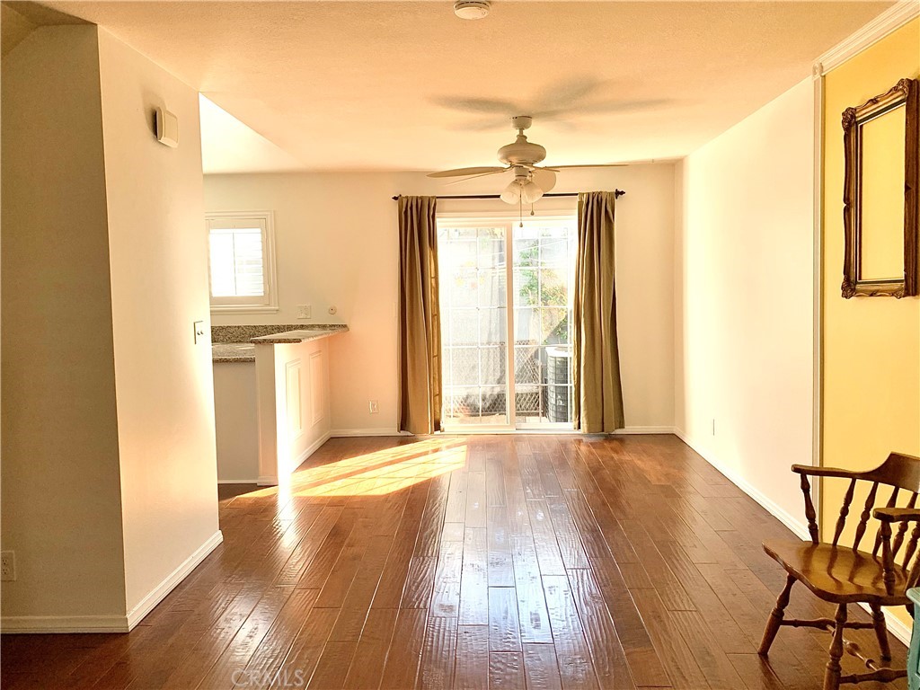 182 Brookline Lane Costa Mesa, CA 92626 - Photo 4 of 21 a view of an empty room with glass door and wooden floor