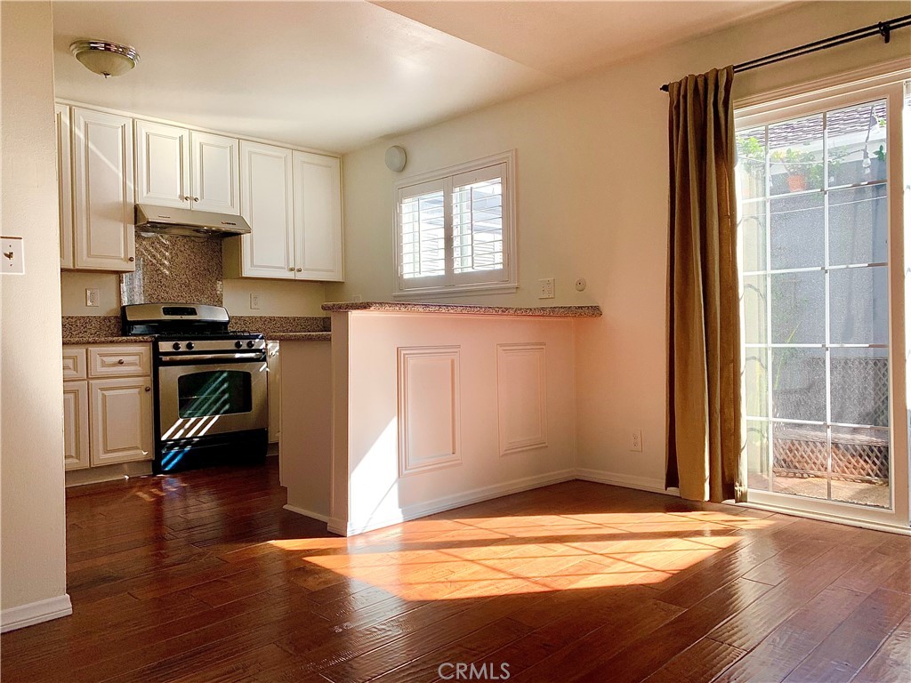 182 Brookline Lane Costa Mesa, CA 92626 - Photo 5 of 21 a view of a kitchen with wooden floor and a window